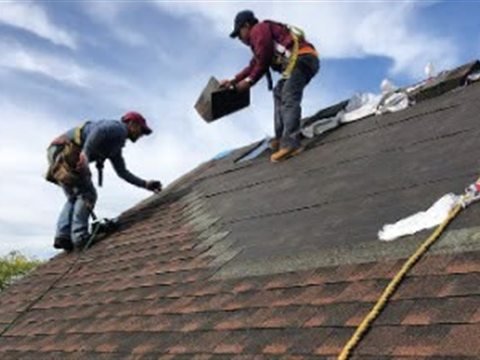Tekno Construction crew installing a shingle roof in NYC